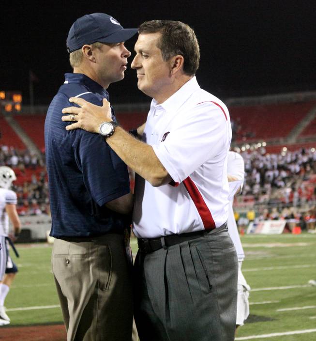 Head coaches Bronco Mendenhall and Mike Sanford shake hands after their game on Oct. 10. BYU beat UNLV, 59-21.