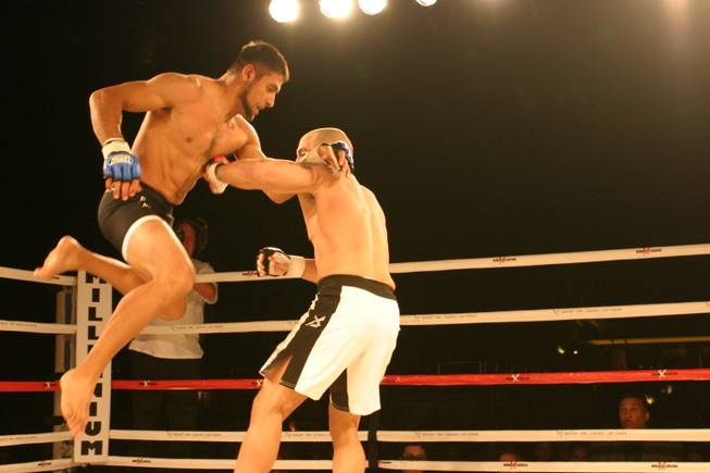 Odis Ruiz comes at Mike Dizak with a flying knee during his pro debut at MMA Xplosion at M Resort.