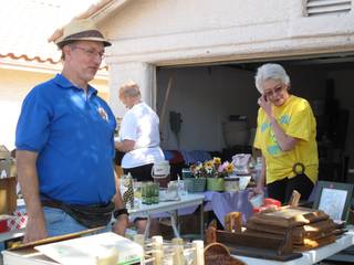 Tall Club members John Morath and Regena Uppleger look at some of the items at the club's semiannual garage sale that raises money for its Tall Awareness scholarship.                               