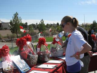 Rebecca Chapin, 13, looks at some of the silent auction prize baskets at the HOPE for Homeless Teenagers Fundraiser on Saturday at the Henderson Parkway Pavilion.