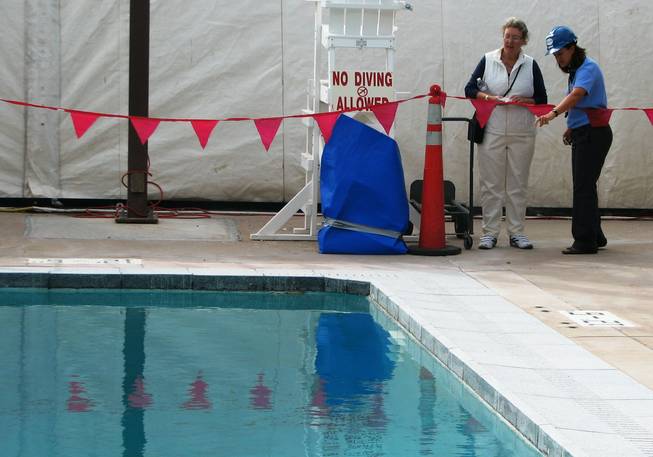 Boulder City Aquatics Coordinator Sheri O'Berto points out the bottom of the outdoor dive pool to resident Angela Smith during a tour of the pool Oct. 13. The pool surfaces were replastered, filtration systems repaired and new coping stones installed. The indoor pool reopens Oct. 19.