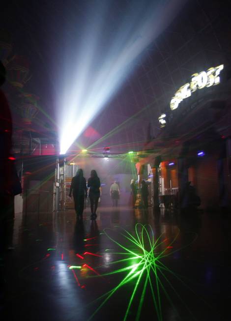 Guests walk through fog and lasers in the Fright Dome ...