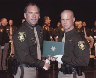 Metro Police Officer Milburn Beitel shakes hands with Sheriff Doug Gillespie. Beitel died Oct. 8 at UMC hours after his cruiser crashed at Nellis Boulevard and Washington Avenue the previous evening.