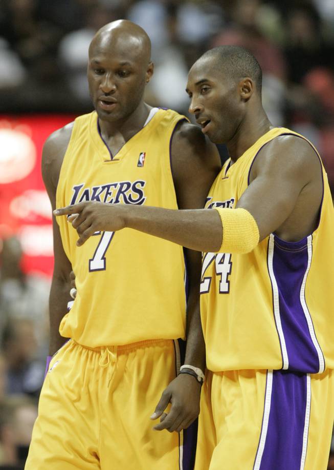 Los Angeles Lakers gaurd Kobe Bryant talks to teammate Lamar Odom during a break in the first half of their exhibition game against the Sacramento Kings Thursday at the Thomas & Mack Center. The Lakers won 98-92.