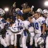 Basic's team celebrates as players hold onto the coveted Henderson Bowl for another year following a 41-14 victory over host Green Valley.