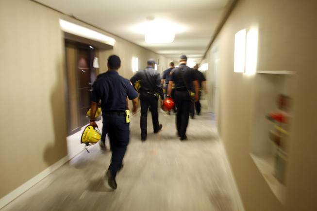 Firefighters go through the a hallway to their next course ...