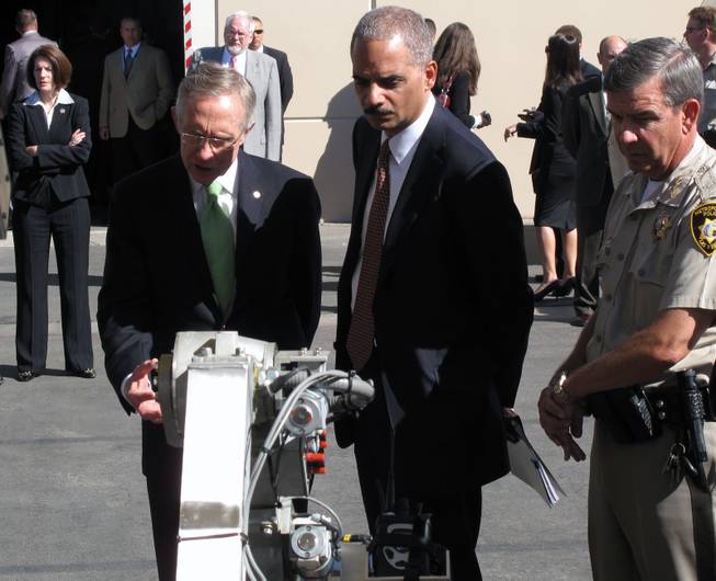 During a tour of the Southern Nevada Counterterrorism Center, Sen. Harry Reid and U.S. Attorney General Eric Holder look at a robot used when police investigate suspicious packages.