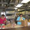 Becky Eighmy, left, and Sue McCullough unpack canned goods and other food at Emergency Aid of Boulder City.  The nonprofit social services agency recently purchased the industrial-grade shelving behind them with a federal grant.
