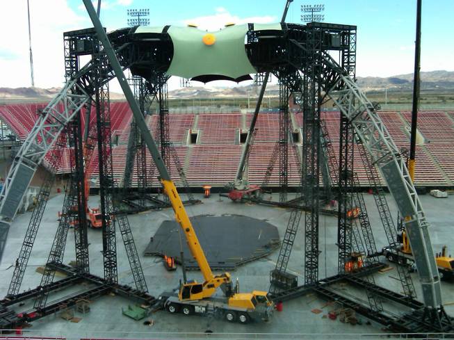 Workers erect the massive 360-degree stage for Friday's U-2 concert ...