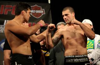 UFC light heavyweight champion Lyoto Machida (left) and challenger Mauricio Rua face-off during the weigh-ins at the L.A. Live Event Deck Friday in Los Angeles.  The two will headline Saturdays fight at the Staples Center.