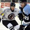 Wranglers left winger Ned Lukacevic (43) eyes the puck as he closes in on Aces defenseman Tyson Marsh during the second period of play at the Orleans Arena on Oct. 24.