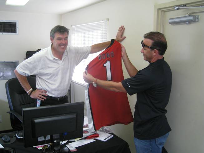 Daren Libonati shows off a new UNLV Runnin' Rebels jersey to Live Nation exec Craig Evans in the hope that Bono might wear it onstage (he didn't).