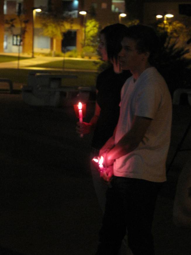 Kylee Tangren, left, and Ryan Ritchie hold candles as part of a vigil held outside the UNLV Student Union Saturday in memory of teenagers who have died in car crashes.