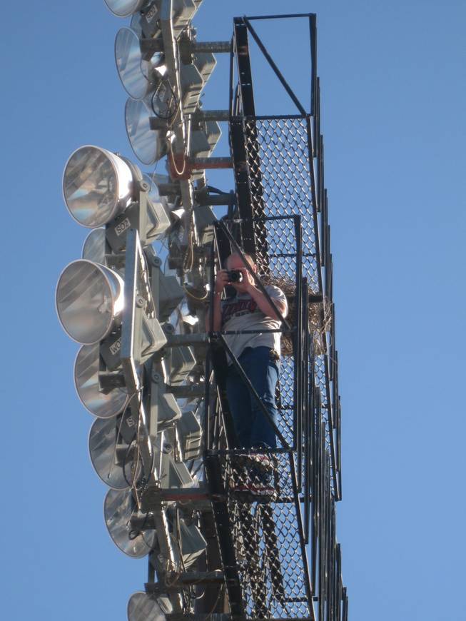 Sam Boyd Stadium Operations Director Jeff Chalfant scales a 150-foot light standard for some unique photographic perspective.