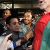 Filipino boxer Manny Pacquiao is led through fans as he arrives at Los Angeles International Airport