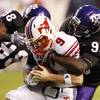 TCU defensive ends Jerry Hughes (98) and Wayne Daniels (96) converge for a sack of SMU's Bo Levi Mitchell in the Horned Frogs' 39-14 victory on Oct. 3. UNLV tackles Evan Marchal and Matt Murphy will have their hands full trying to slow down the duo this Saturday in Fort Worth.