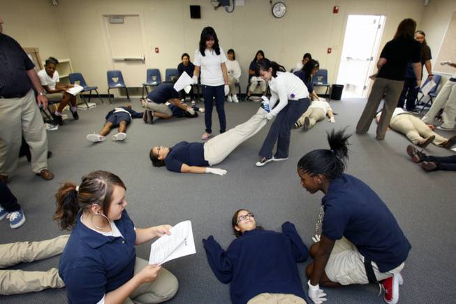 Eighth grade girls practice basic CPR techniques during a health class at West Prep on Tuesday. At bottom are: Klarissa Gilley, left, and Yahaira Morales, center, and Uchenna Scott. 