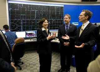 Labor Secretary Hilda Solis, left, talks with Charlie Randall, center, business manager for the International Brotherhood of Electrical Workers Local 396, and Michael Yackira, president and CEO of NV Energy, during a tour of a NV Energy control room Wednesday, Oct. 28, 2009.  Solis announced the award of $138 million in federal stimulus funds to NV Energy for smart grid technology. The money will fund a three-year project to replace electric meters with 