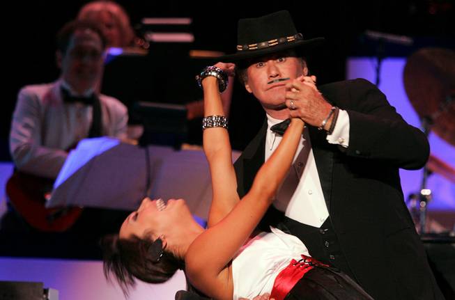 Wayne Newton performs with his former "Dancing With The Stars" partner Cheryl Burke during the grand opening night of Wayne Newton's "Once Before I Go" at the Tropicana in Las Vegas Wednesday, Oct. 28, 2009. 