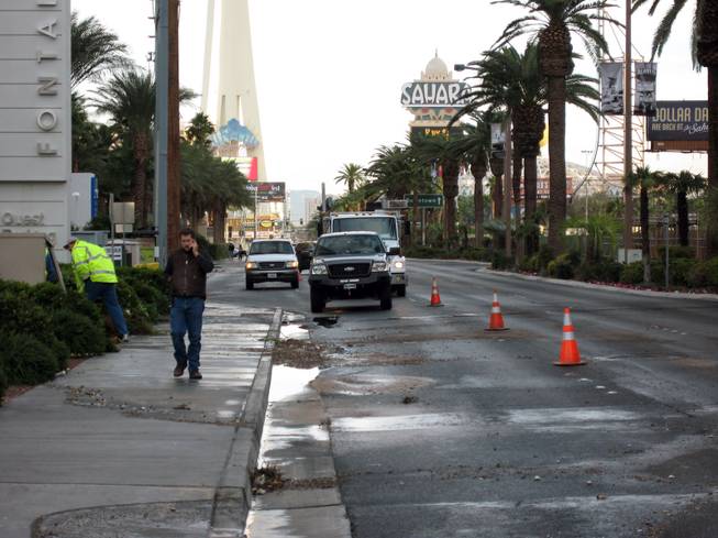 Crews work on a broken water valve near Las Vegas Boulevard Friday morning after the valve burst, sending water cascading down the Strip across from the Fontainebleau.