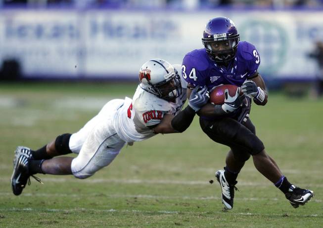 TCU running back Ed Wesley (34) is tackled by UNLV linebacker Jason Beauchamp in the second half Saturday, Oct. 31, 2009, in Fort Worth, Texas. TCU defeated UNLV 41-0. 