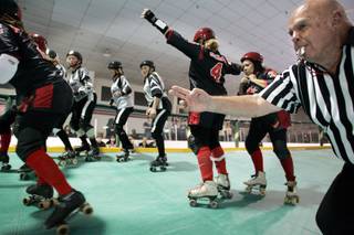 Referee Don Lastra signals the beginning of a period of play as the Las Vegas High Rollers play the Los Angeles Black Hawks in a roller derby match at the Las Vegas Roller Hockey Center Saturday, Oct. 31, 2009. Lastra, or 