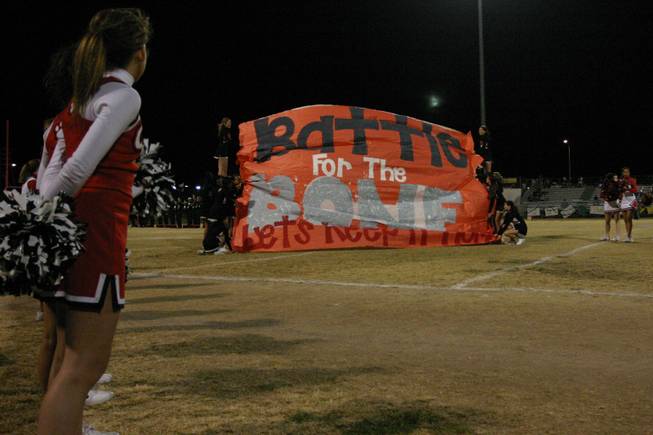 The Las Vegas High School cheerleaders prepare for the football team's entrance before the annual Bone Game against Rancho High School.