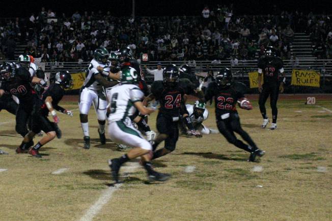 Michael Glenn (24) prepares to block for fellow Wildcat Cameron Rogers (22) during the first quarter of Thursday night's Bone Game against Rancho.
