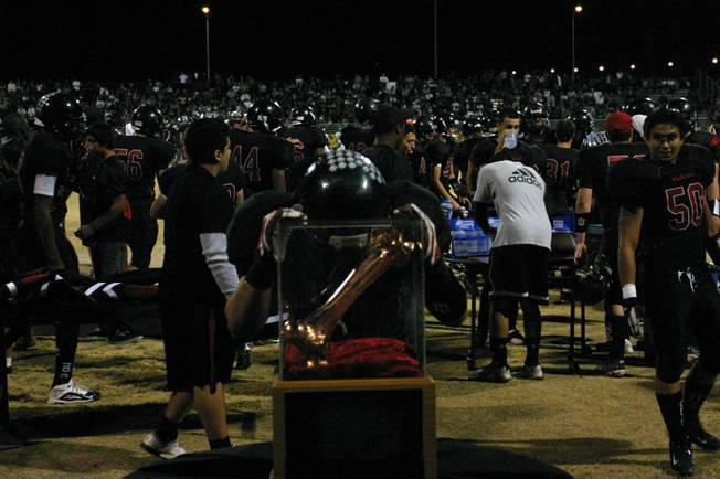 Las Vegas linebacker David Prieto (9) spends a moment with Sir Herkimers Bone before the annual game against Rancho Thursday night.