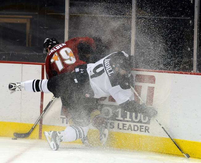 Wranglers defenseman Mike Madill collides with Bakersfield winger Kyle Calder in a flurry of snow during the first period of play at the Orleans Arena on Thursday night.