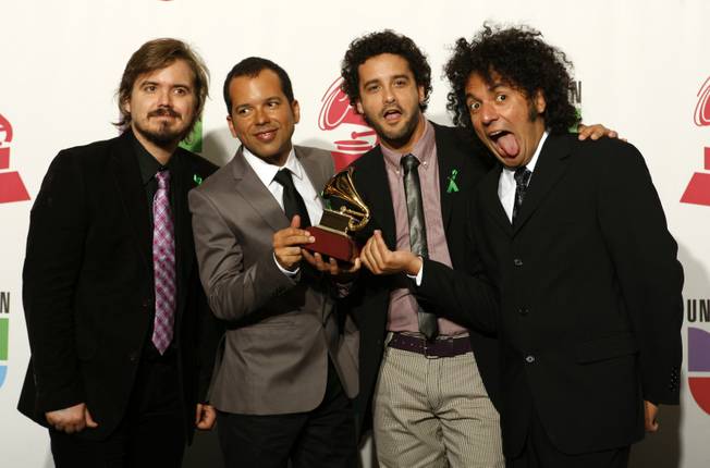 Members of Los Amigos Invisibles pose with their Grammy for Best Alternative Music Album at the 10th annual Latin Grammy Awards at the Mandalay Bay Events Center.