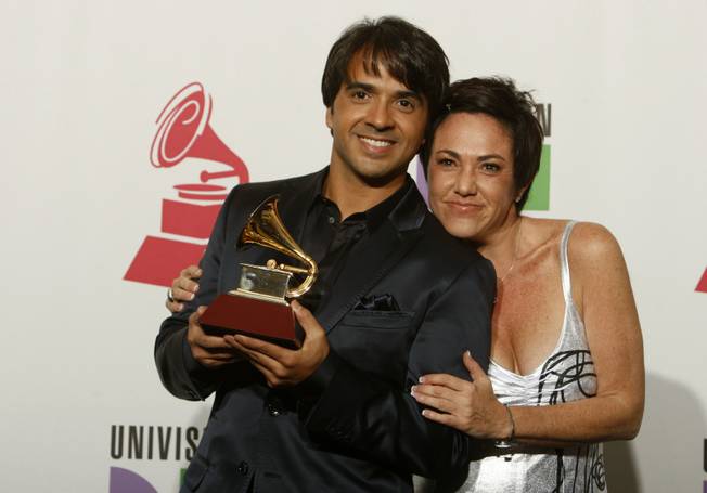 Luis Fonsi and Claudia Brant pose with the Grammy for Song of the Year at the 10th annual Latin Grammy Awards at the Mandalay Bay Events Center. The pair shared the award for "Aqui Estoy Yo" with Gen Rubin.