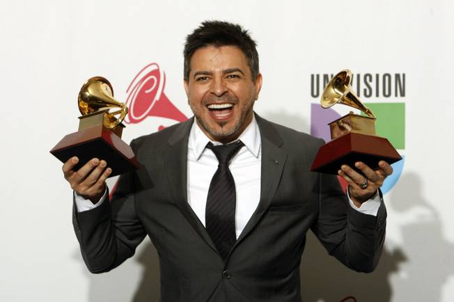 Luis Enrique poses with his awards at the 10th annual Latin Grammy Awards at the Mandalay Bay Events Center Thursday.