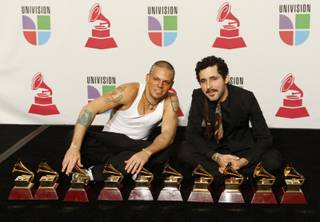Rene Perez, left, and Eduardo Jose Cabra Martinez of the musical group Calle 13 pose with their awards at the 10th annual Latin Grammy Awards at the Mandalay Bay Events Center.