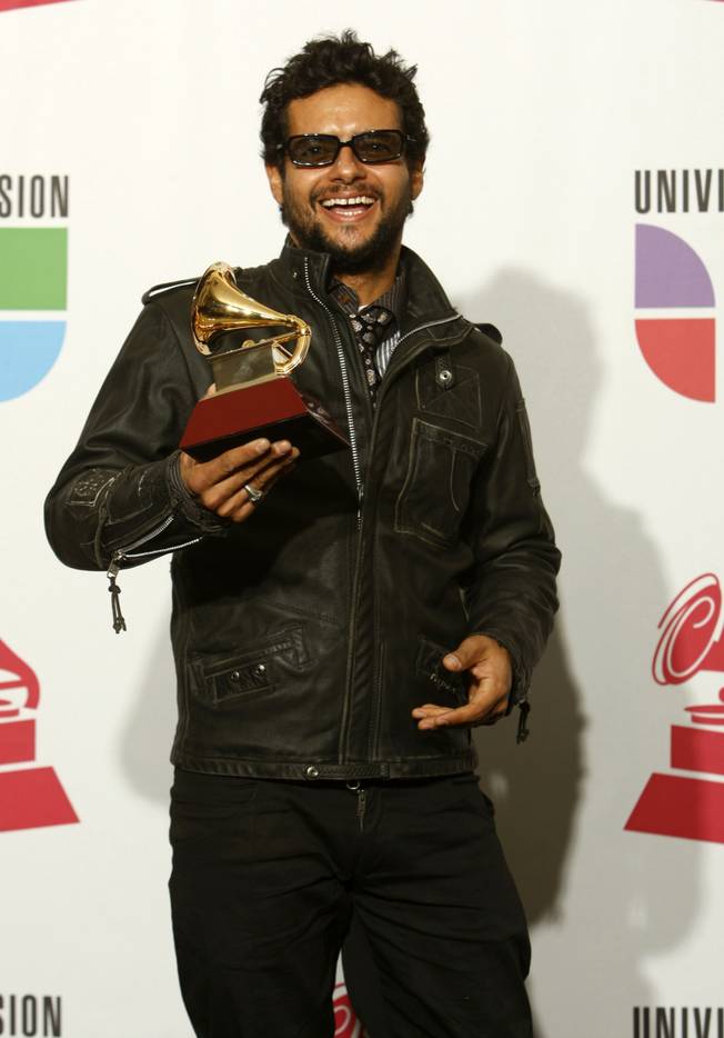 Robi Draco Rosa poses with his award for Best Rock Solo Vocal Album at the 10th annual Latin Grammy Awards at the Mandalay Bay Events Center.