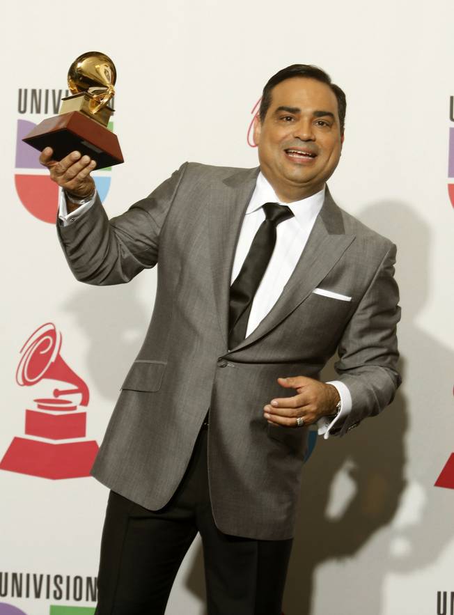 Gilberto Santa Rosa poses with the award for Best Traditional Tropical Album at the 10th annual Latin Grammy Awards at the Mandalay Bay Events Center.