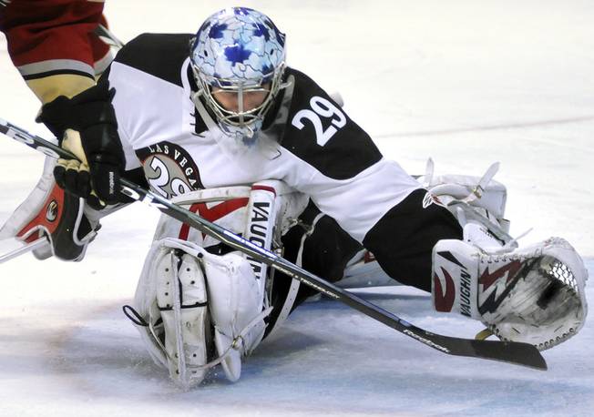 Seemingly beaten on the play, Wranglers goaltender Michael Ouzas flashes the leather to rip the puck right off the blade of the stick of Condors winger Stephane Goulet to preserve a 2-1 lead in the third period at the Orleans Arena on Friday night. Ouzas made 37 saves to improve his personal record to 5-2.