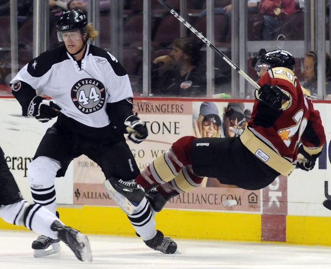 Shay Stephensen (44) sends Bakersfield's Eric Regan flying during the second period at the Orleans on Friday night.