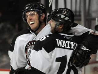 Wranglers wingers Andrew Orpik, left, and Matt Watkins celebrate a power play goal scored by Watkins against the Condors in the second period on Friday night. The goal would be the eventual game winner of the night, with both players being named top stars in the contest.