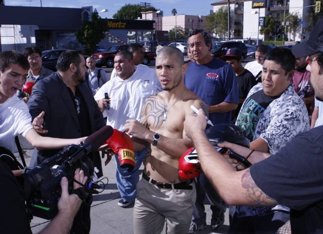 WBO welterweight champion Miguel Cotto, center, of Puerto Rico is besieged by autograph hunters outside the Pound4Pound Gym in Los Angeles on Tuesday, Nov. 3, 2009. Cotto is scheduled to defend his title against Manny Pacquiao of the Philippines at the MGM Grand Garden Arena on Nov. 14. 