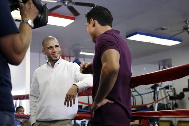 WBO welterweight champion Miguel Cotto, left, of Puerto Rico is interviewed by television host Mario Lopez for NBC's "Extra" following  a workout at the Pound4Pound Gym in Los Angeles on Tuesday, Nov. 3, 2009. Cotto is scheduled to defend his title against Manny Pacquiao of the Philippines at the MGM Grand Garden Arena on Nov. 14. 