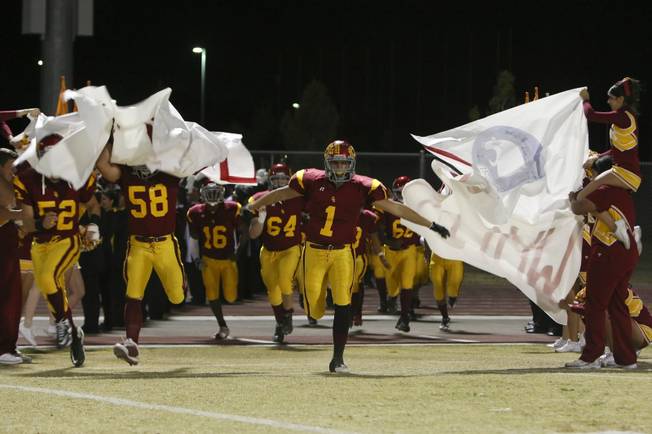 The Del Sol football team storms the field Friday night before facing visiting Coronado.