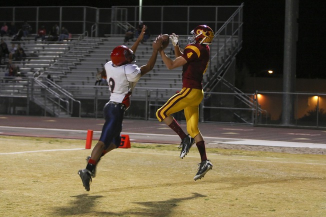 Del Sol wide receiver Evan Weinstock makes a catch in the end zone above Coronado defensive back Chris Johnson with 13 seconds to play before halftime to give the Dragons momentum for the second half. Weinstock finished with two touchdowns and the Dragons beat Coronado 46-26 to win the Southeast Division title.