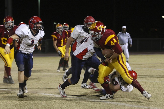 Del Sol fullback Kip Canyon slips past Coronado defenders for a short gain Friday in the Dragons 46-26 victory to clinch the Southeast Division title.