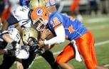 Bishop Gorman freshman quarterback Anu Solomon runs into the Cheyenne Desert Shields line Friday night in the Sunset Regional quarterfinals. Gorman dominated with a 56-15 victory.