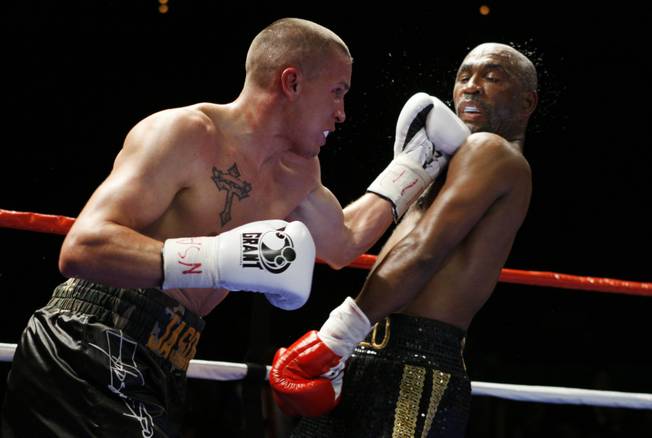 Former WBC lightweight champion Joel Casamayor, right, gets caught by an uppercut from Jason Davis during a eight-round super lightweight fight at The Pearl in The Palms Friday. Casamayor won the fight by unanimous decision.
