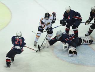 Germany's Thomas Greilinger, second left, and US Lee Sweatt and his teammates Charlie Cook, goalkeeper Jeanmarc Pelletier and Jeff Hamilton, left to right, challenge for the puk during the ice hockey Germany Cup match between Germany and USA in the Olympic hall in Munich, southern Germany, on Friday, Nov. 6, 2009. USA won the match after penalty 3-2. 