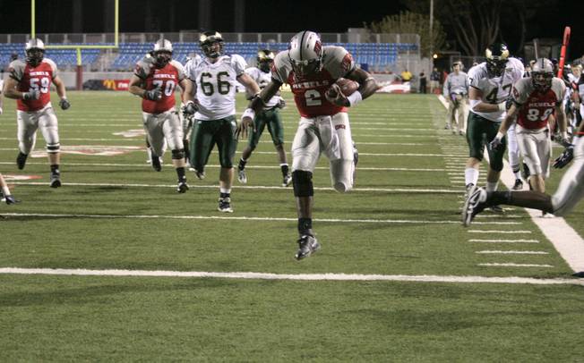 UNLV quarterback Omar Clayton skips over the goal line during the first half of Saturday's game against Colorado State at Sam Boyd Stadium.