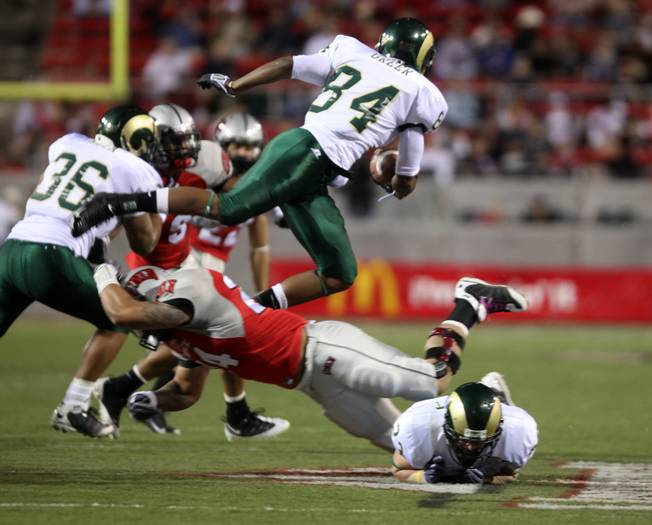 Colorado St. receiver Rashaun Green attempts to jump over the UNLV defense during the game at Sam Boyd Stadium Saturday.  UNLV came out on top 35-16..