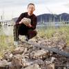 UNLV's David Wong holds a rock covered with dead quagga mussels. The researcher's goal is to elimina